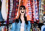 Large_MS PPT_Web-Young girl wearing silly glasses with a fake nose while standing between a rack full of colored blouses..jpg