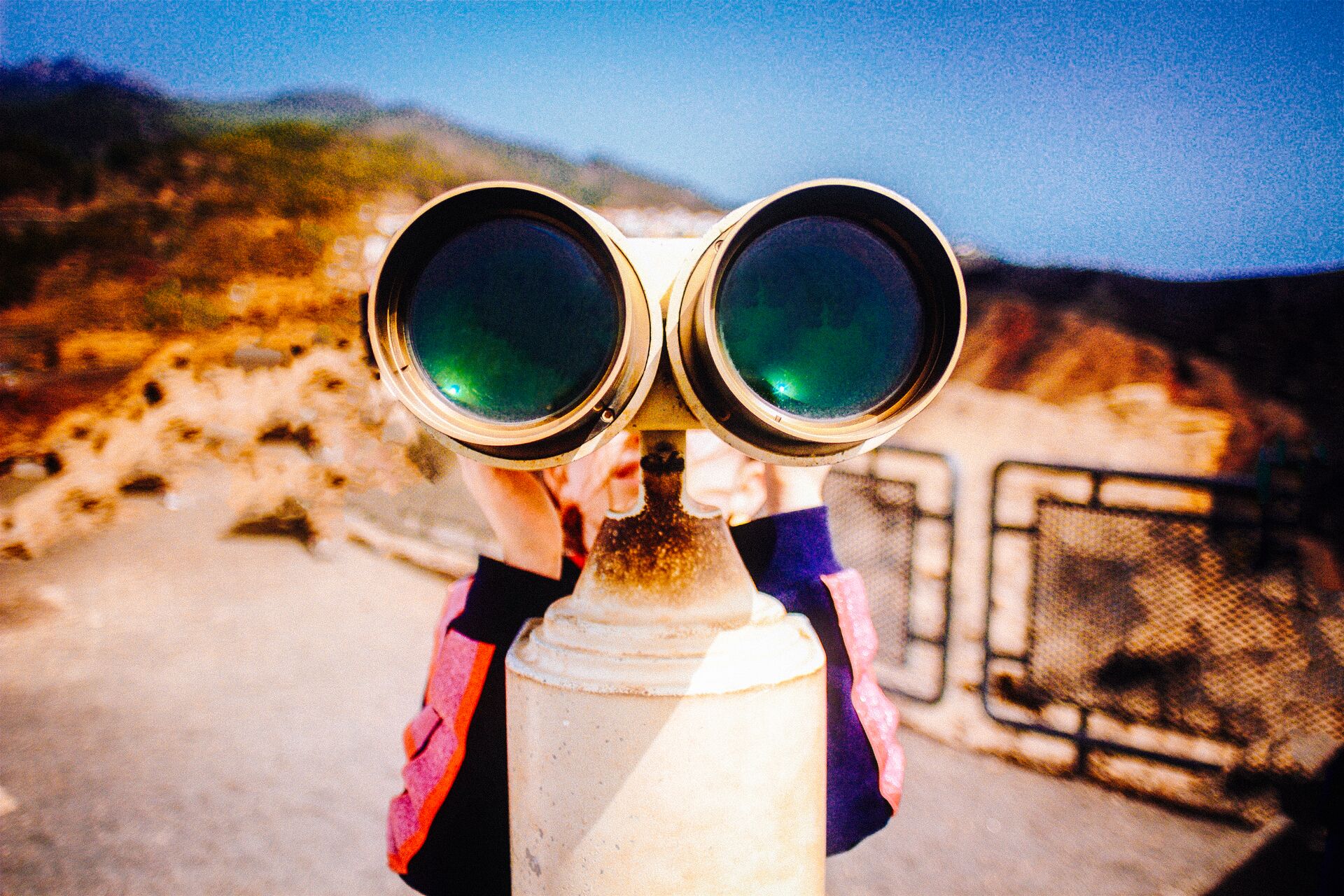 Large_MS PPT_Web-Close up of person looking through some binoculars outdoors .jpg