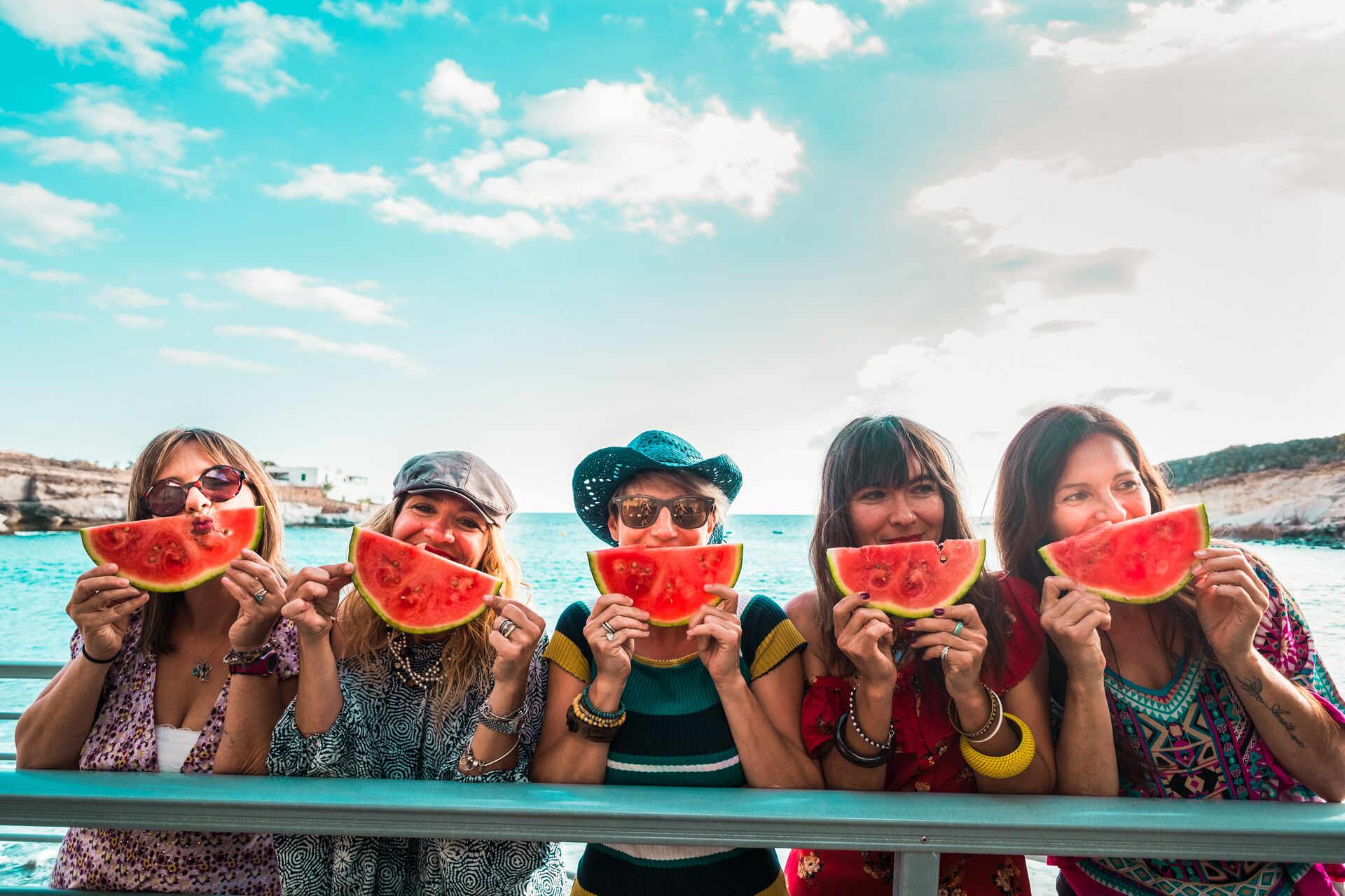 Large_MS PPT_Web-Women on vacation posing for a photo with watermelon slices.jpg
