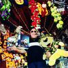 Large_MS PPT_Web-Bald man holding a remote-controlled car and big yellow stuffed animal at a fair.jpg