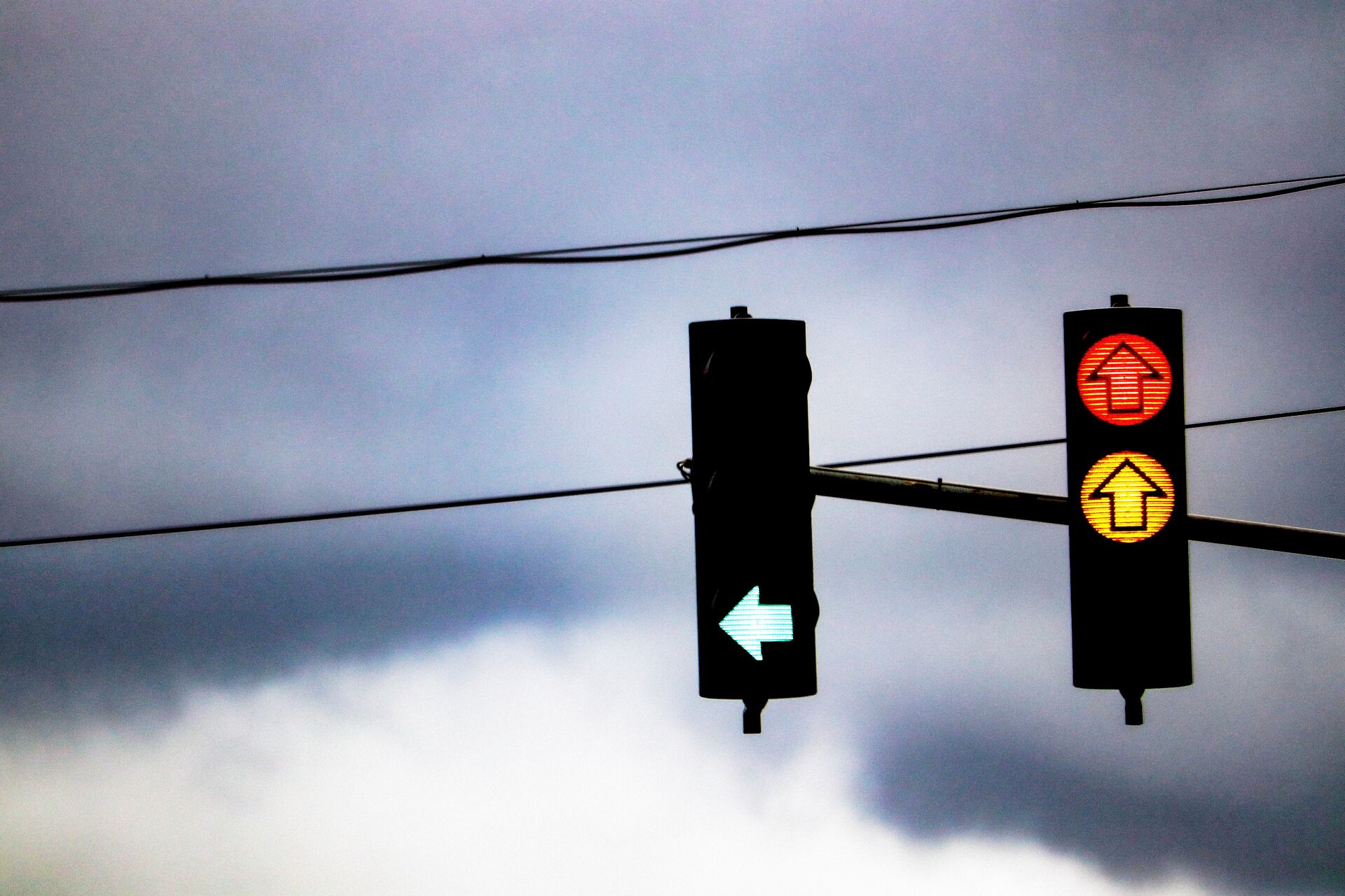 Large_MS PPT_Web-Close up of arrows on traffic lights against a gloomy sky.jpg