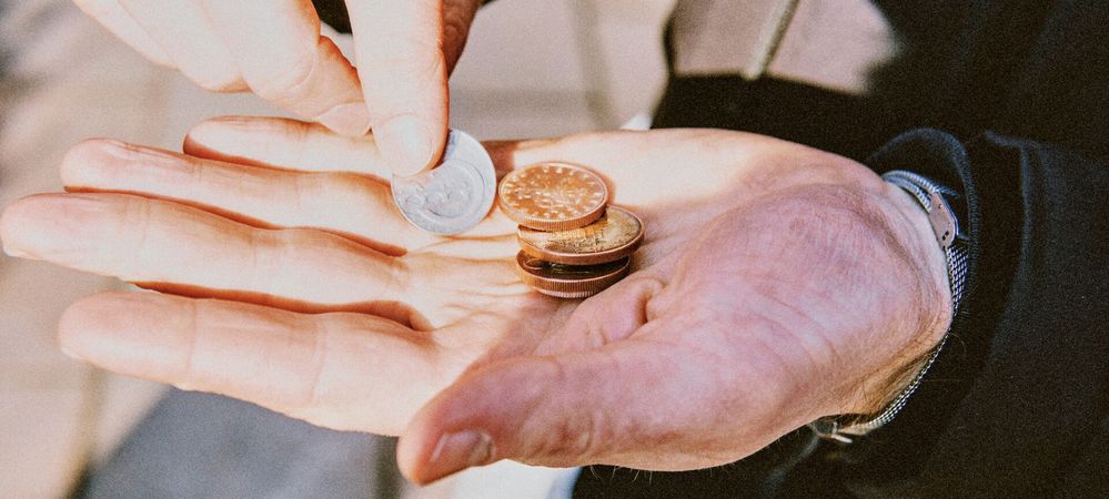 Large_MS PPT_Web-High angle view of hand holding coin.jpg