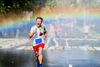 Large_MS PPT_Web-A happy young man screams as he runs a marathon in the rain, causing a rainbow to form behind him.jpg