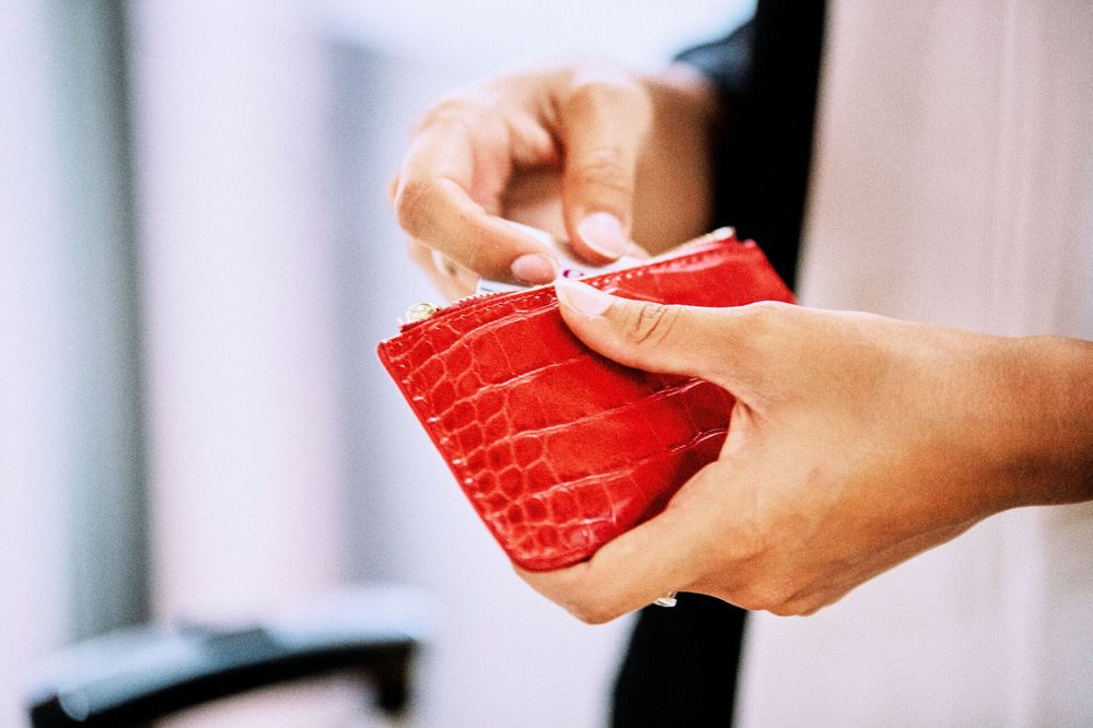 Large_MS PPT_Web-Close up of a person holding a small red wallet.jpg