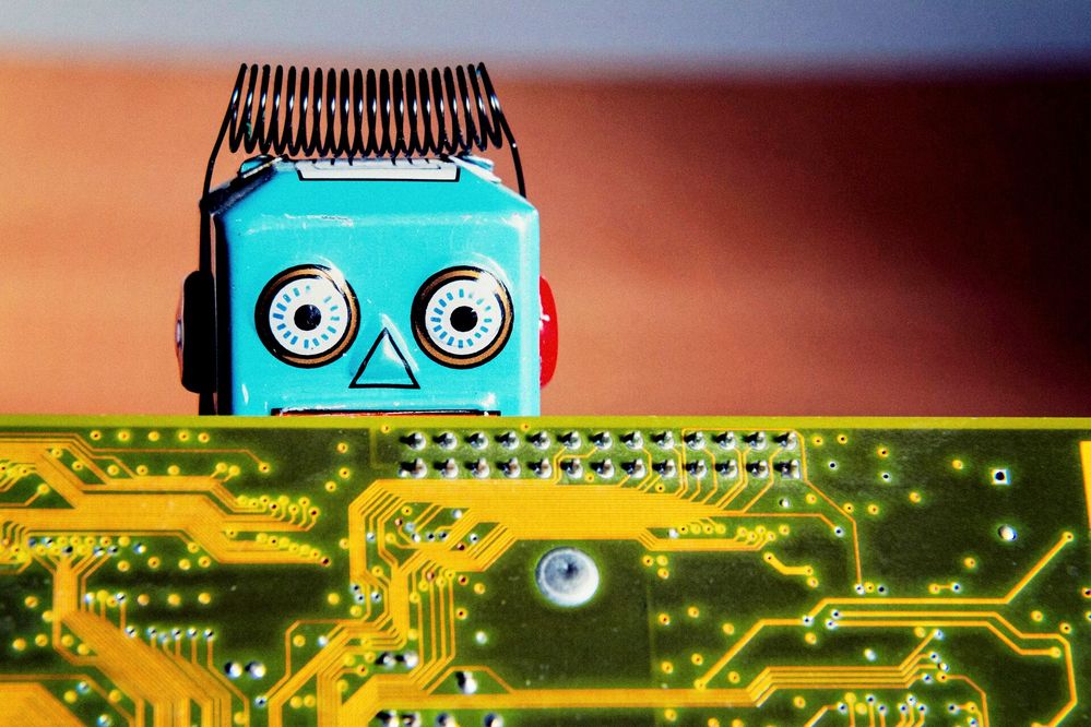 Large_Web and Screen-A close up of a toy robot peaking over the top of a circuit board.jpg