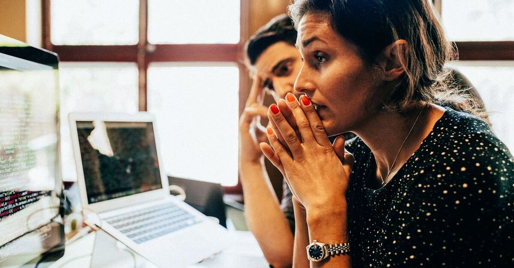 Woman and man look concentrated to computer screen.jpg
